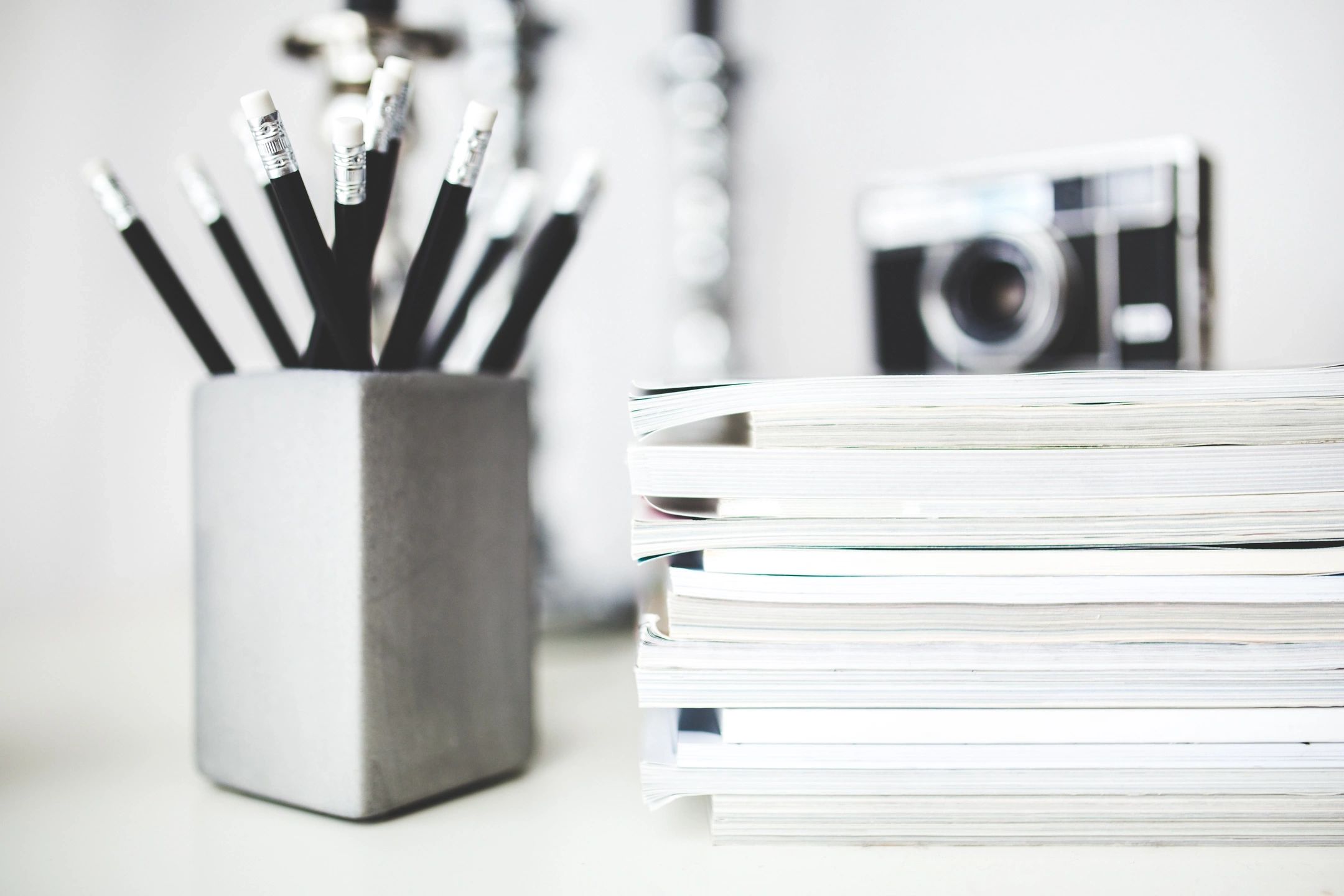 Stack of books and pencils representing HR policy and employment contract resources